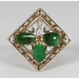 A 14K gold, jade and diamond set ring, the filigree square top modelled as a clover leaf, 4.5 grams,