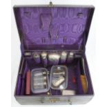 A ladies 19th century purple leather travel case together with eleven various silver-topped glass