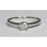 An 18ct white gold ring by Tolkowsky, the pierced band centrally four-claw set with a solitaire