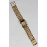 A ladies 1950s Omega wristwatch, with 9ct gold curved rectangular case, and engine-turned