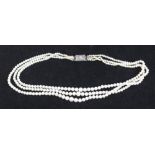 A three-row necklace of graduated cultured pearls graduating from 2.5mm to 6.4mm, with silver