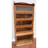 A Lebus five section oak Globe Wernicke 'style bookcase' with up-and-over glazed doors, 88cm wide