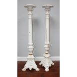 A pair of white painted Coalbrookdale 'style' cast iron pricket torchere stands, with campagna tops,