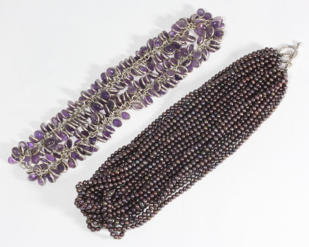 A white metal and multi-drop cabochon cut amethyst necklace, together with a multi-strand black