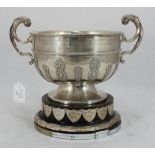 A large silver circular twin-handled presentation bowl decorated with strapwork, engraved 'Potato