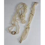 A double stringed necklace of cultured pearls, individually knotted, pearl diameter 7mm, necklace