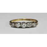 An 18ct gold and platinum five-stone diamond ring, platinum claw-set, graduated brilliant-cut and