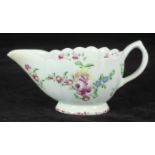 A Bow porcelain sauce boat of fluted form, painted in polychrome enamels with roses, 15cm long,