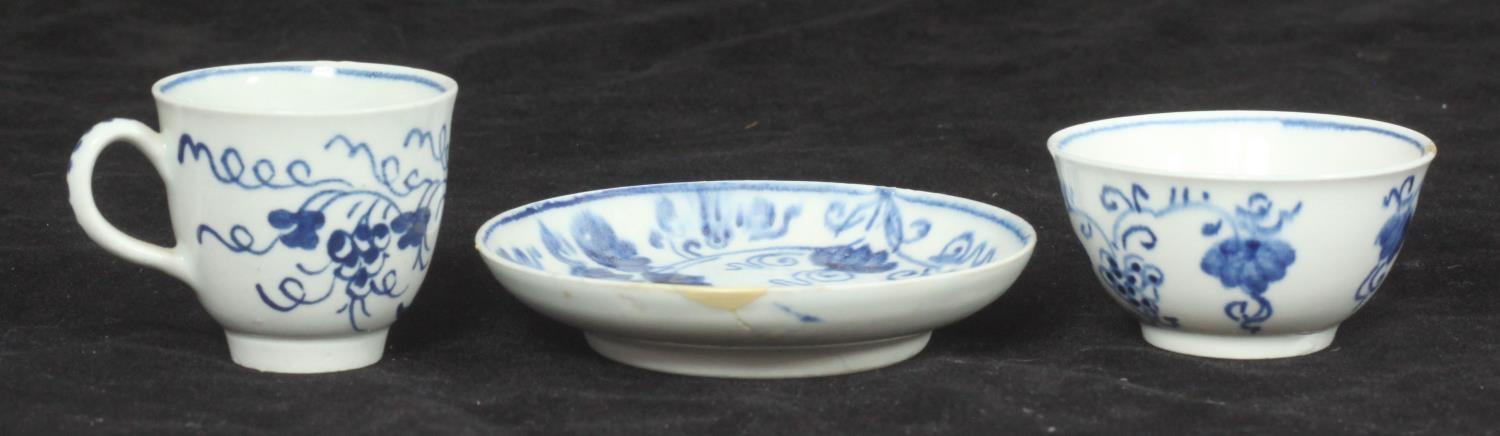 A Bow porcelain miniature tea bowl, saucer and coffee cup painted in underglaze blue in the '