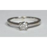 An 18ct white gold ring by Tolkowsky, the pierced band centrally four-claw set with a solitaire