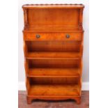 A small yew wood veneered Waring & Gillow bookcase, with open shelf, above a single drawer over