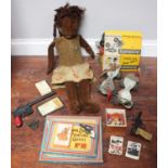 A vintage black cloth musical doll circa 1930s, together with two pairs of roller skates, Man from