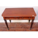 A Victorian mahogany side table, with two frieze drawers, raised on turned and reeded supports to