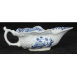 A Worcester blue & white sauce boat, c1755, moulded with cartouches, shaped rim and scroll handle,