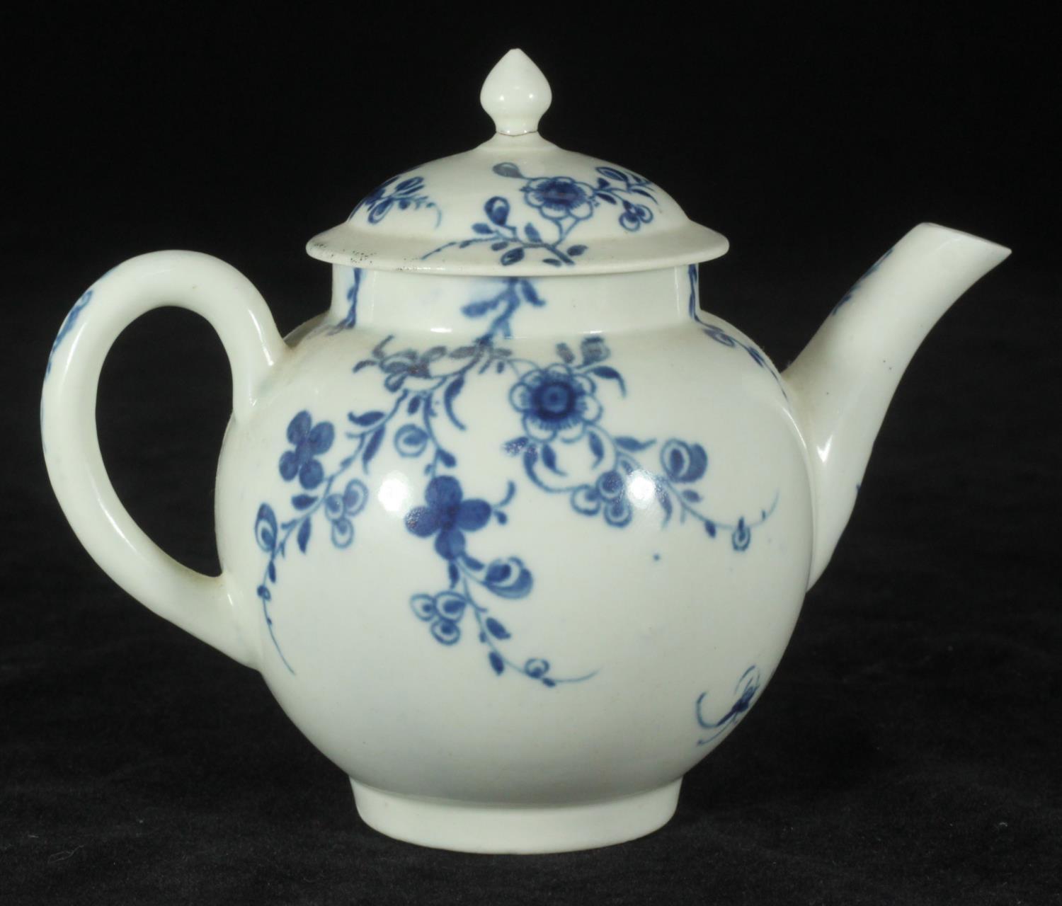 A Worcester porcelain small globular teapot and cover, c1760, decorated in underglaze with the
