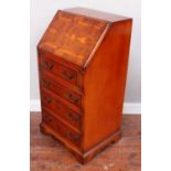 A small yew wood veneered Waring and Gillow bureau, the fall front opening to reveal a fitted