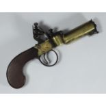 An early 19th century brass flintlock tinder lighter, with stained wooden stock and ornate,