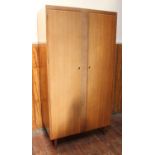 A three piece, mid-20th century, mahogany veneered bedroom suite by 'Wrighton', comprising a two-