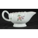 A Derby porcelain cream boat of oval form with vertical reeded body, on circular foot, painted on-