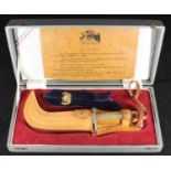 A Chilean Army 'El Corvo' knife in leather sheath and red velvet lined presentation case with an