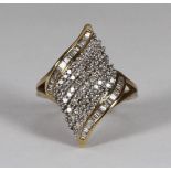 A 9ct gold and diamond dress ring of fancy-swirl design, pave-set to the central band with approx.