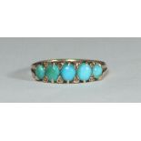 A 14ct gold bridge ring set with graduated turquoise and small diamonds. Total weight of ring 2.