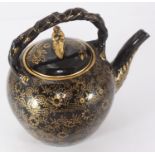 A 19th century Wedgwood ceramic teapot, finished in black with a gold floral design and gilt figural