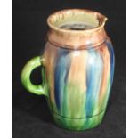 A 20th century 'Whieldon' style pottery jug, finished in a blue, brown and green glaze, impressed