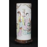 A Chinese porcelain cylindrical vase painted with female figures a garden, in polychrome, and a
