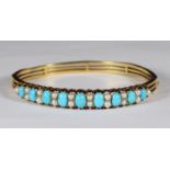 An 18ct gold bangle set with oval turquoise and pearls. Total weight of bangle 21.2g