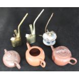 Three assorted Yixing pottery teapots, together with three various opium pipes, one brass, one white