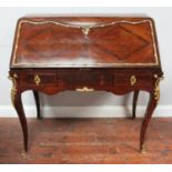 An 18th Century French rosewood and gilt bronze mounted bureau, opening to reveal fitted interior