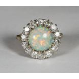 An 18ct gold cluster ring claw-set with a central round opal surrounded by fourteen round