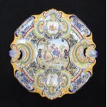 A 19th century large Majolica charger of cartouche form with shell handles, decorated in
