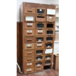 An oak haberdashery unit with three columns of ten drawers each, maker's plate 'Dudley & Co Ltd