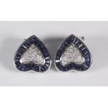 A pair of 18ct white gold heart shaped stud earrings each with a pave diamond set centre, surrounded