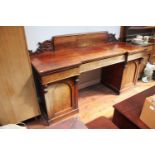 A Victorian mahogany inverted breakfront, pedestal, chiffonier sideboard, the raised and scrolled
