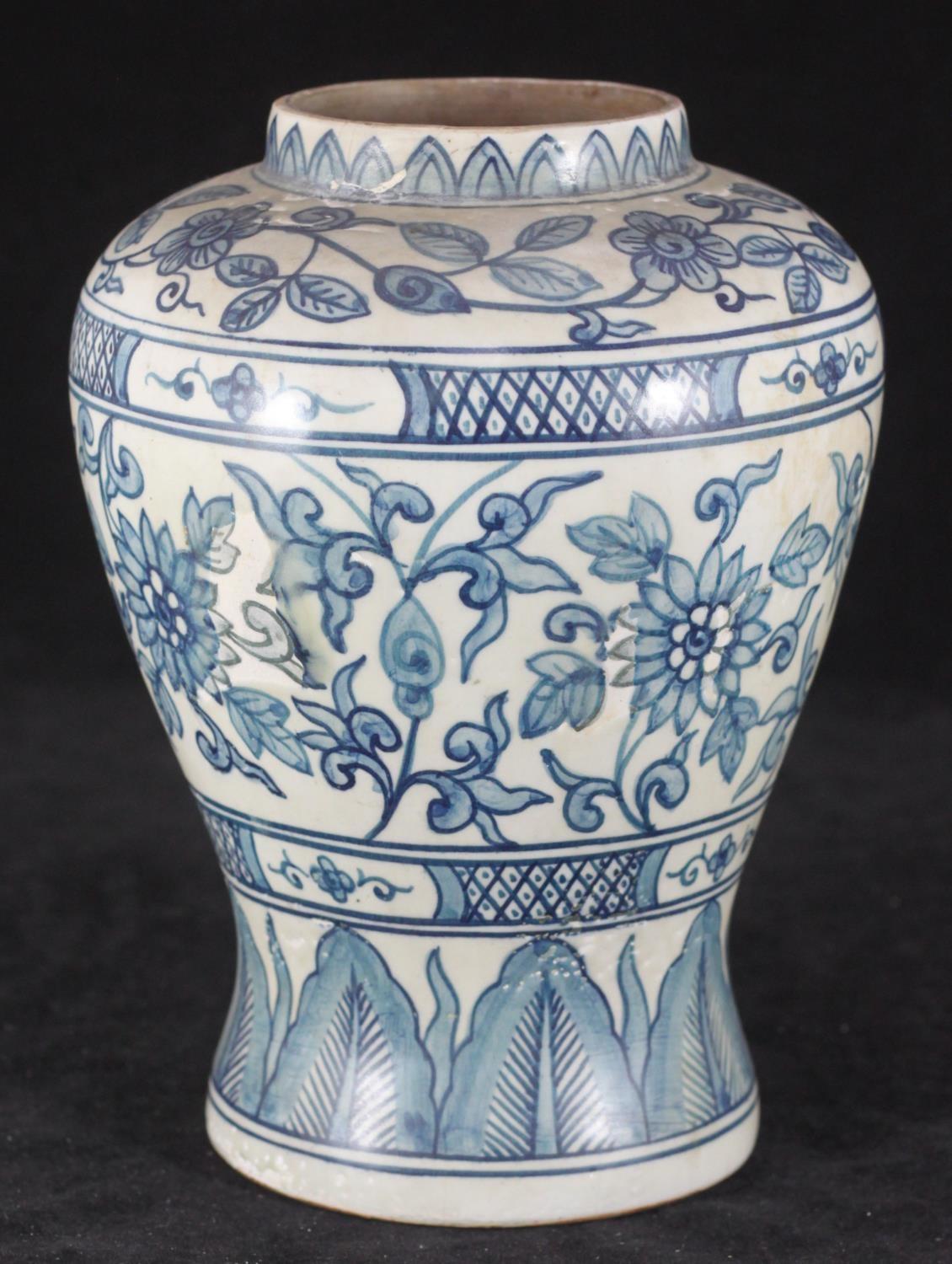 A Chinese pottery vase of inverted baluster form, decorated in a blue and white floral design.
