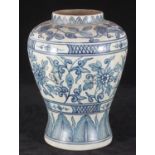 A Chinese pottery vase of inverted baluster form, decorated in a blue and white floral design.