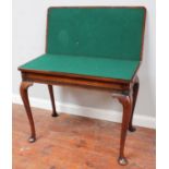 A good quality early 20th century mahogany folding card table, the top opening to reveal a green