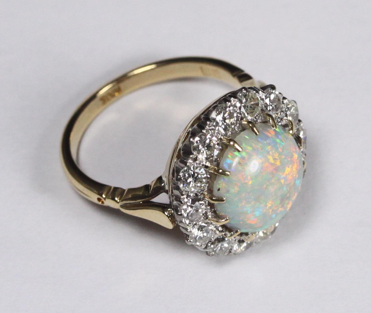 An 18ct gold cluster ring claw-set with a central round opal surrounded by fourteen round - Bild 2 aus 2