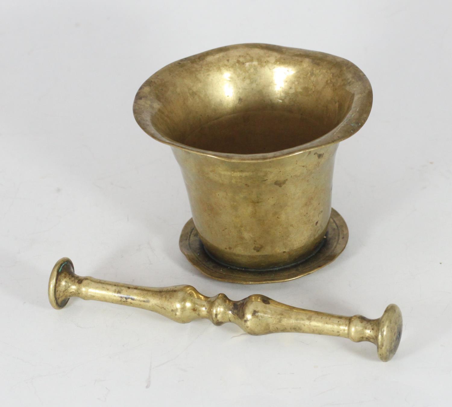 A 17th/18th Century polished bronze pestle and mortar.