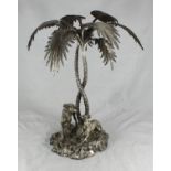 A silver-plated centrepiece modelled with two Greyhounds beneath a Palm tree on naturalistic base