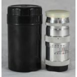 A Russian USSR period 'Jupiter' camera lens, with lens caps and two-piece cylindrical plastic case