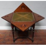 An Edwardian walnut envelope card table, the top enclosing a gilt-tooled green playing baize,