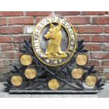 A large cast metal 'Whitbread & Company 1742' sign, painted in black and gold, the central oval