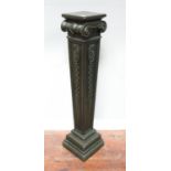 A bronzed painted pedestal of squared, tapering form, with ionic capital, above a body decorated