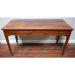 An Edwardian mahogany writing desk by Howard & Sons Ltd, the quarter-veneered flame mahogany top