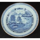An 18th century delft circular charger, painted in underglaze cobalt blue with the 'Temple' design