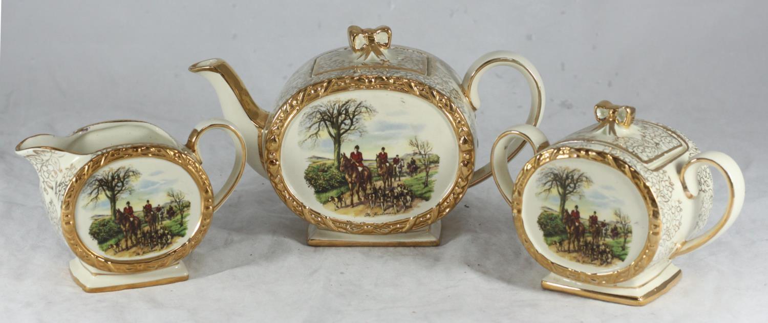 A Sadler three-piece tea set with 'The Huntsman' scene comprising teapot, sugar bowl and milk jug